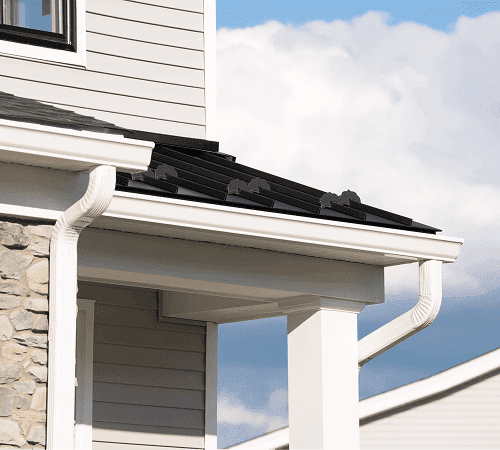 White gutter system installed along a home roofline