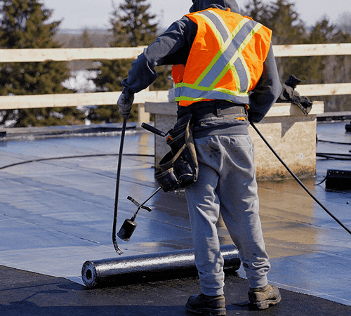 Commercial roofer working on a flat roofing system