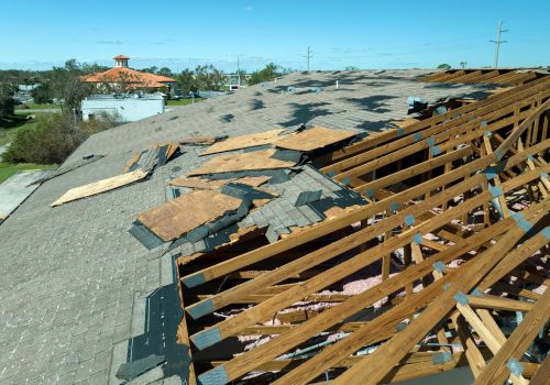 Damaged roof shingles after severe storm damage Damaged roof shingles after severe storm damage